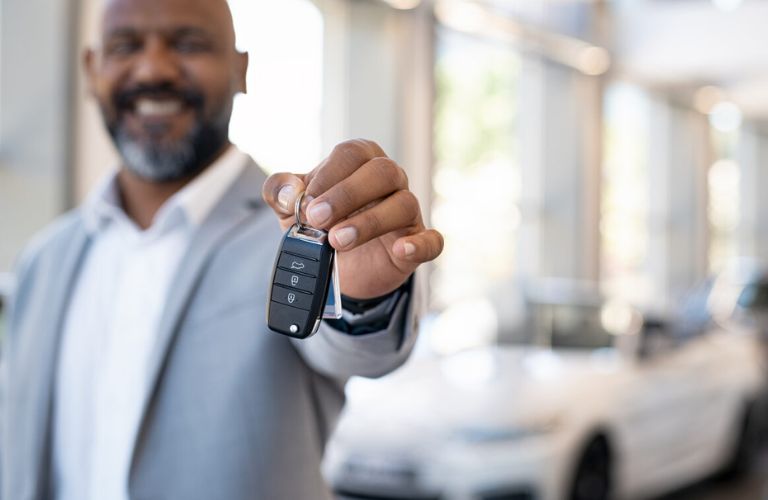 A person showing car keys